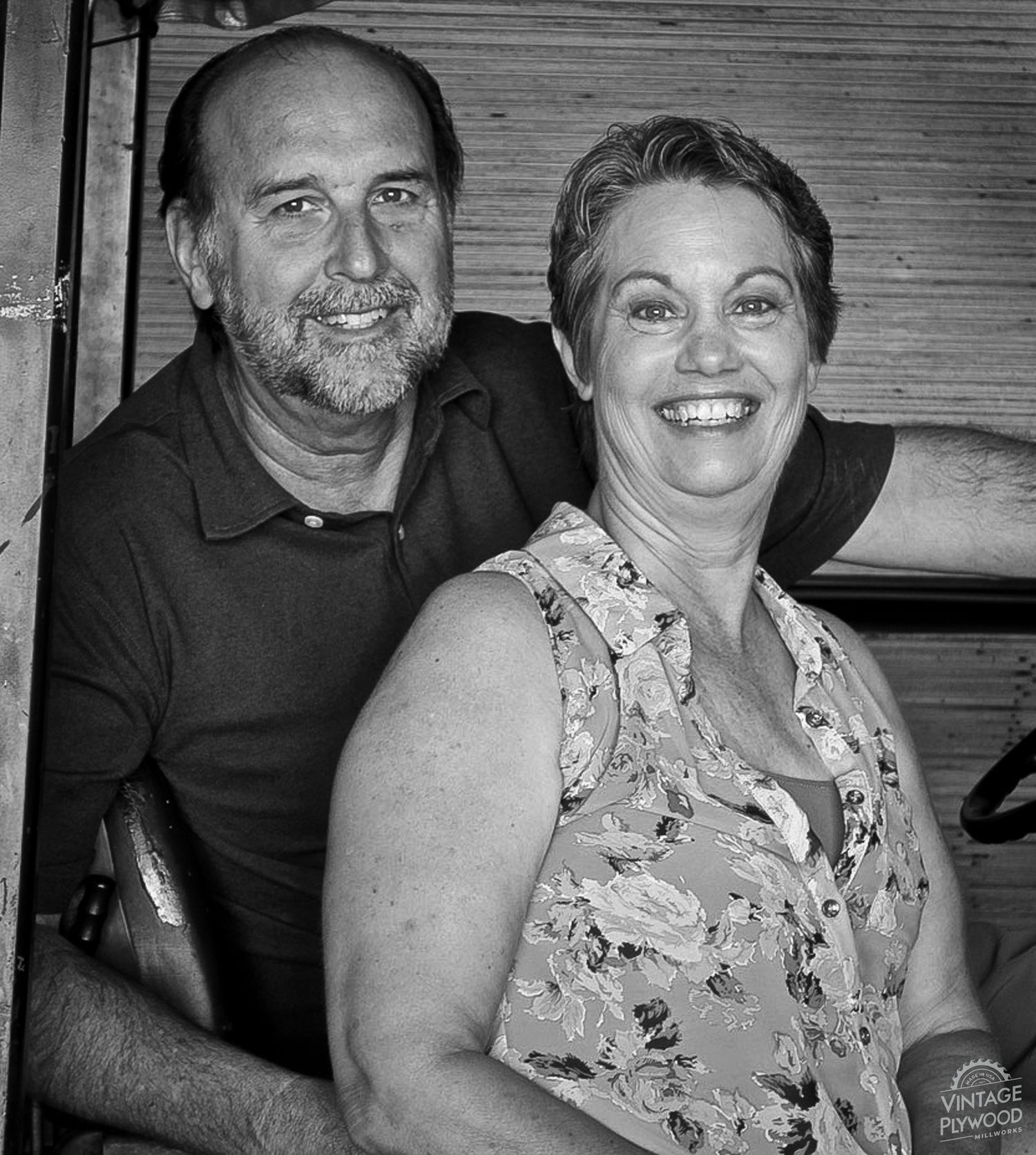 Jeff and Annette Nichols, owners of Vintage Plywood Millworks, smiling while sitting on a forklift