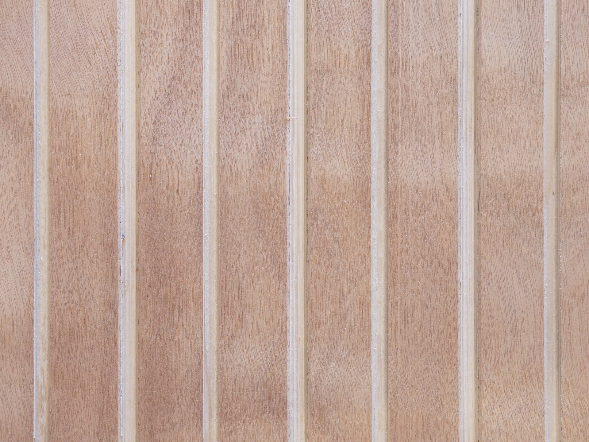 Close up of Vintage Plywood Millworks' Wideline siding showing the wide grooves and wood grain pattern