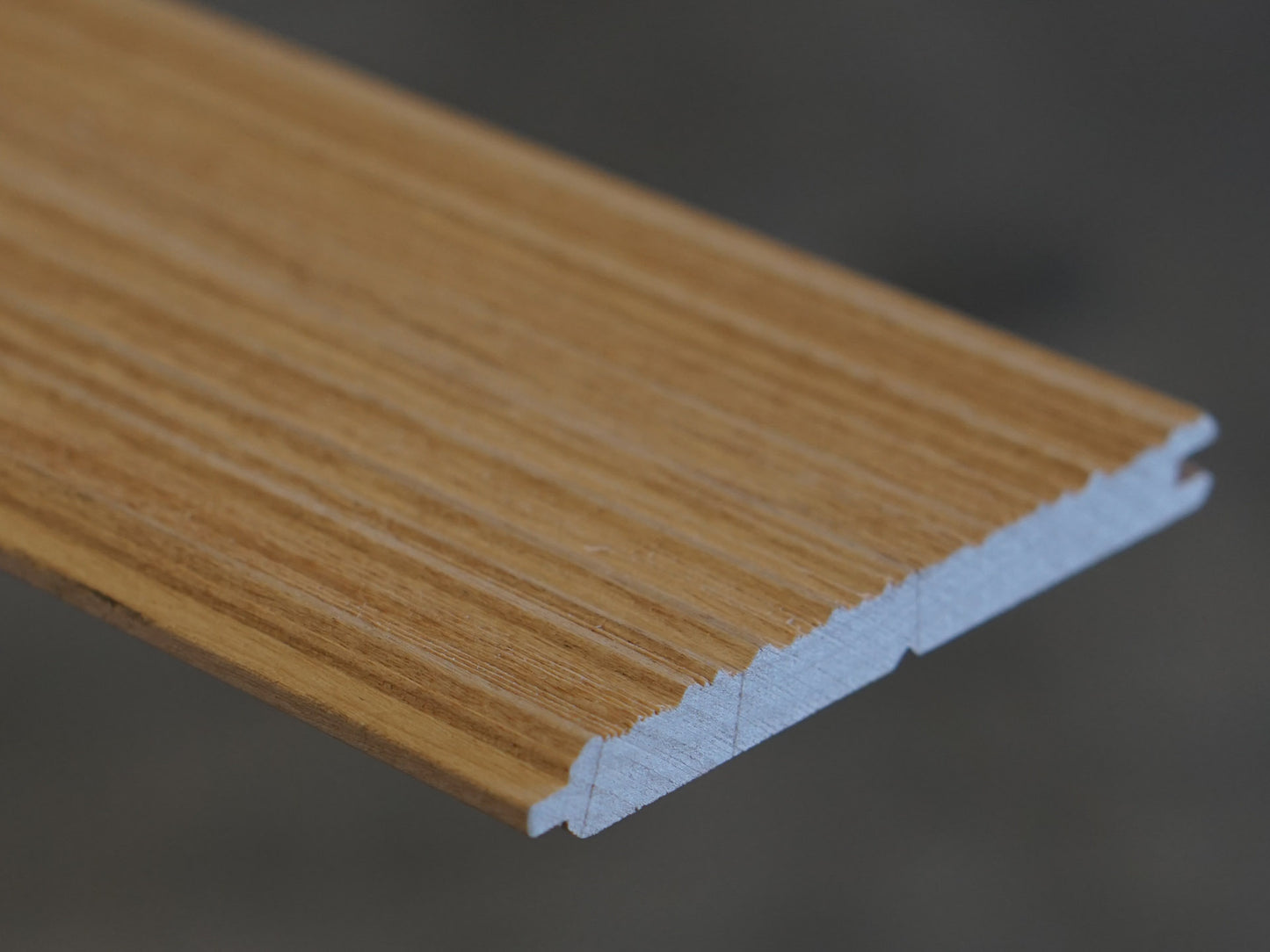 Close up of Weldtex tongue & groove alder hardwood plank consisting of a combed, striated, brushed wood appearance common in mid-century modern homes and design
