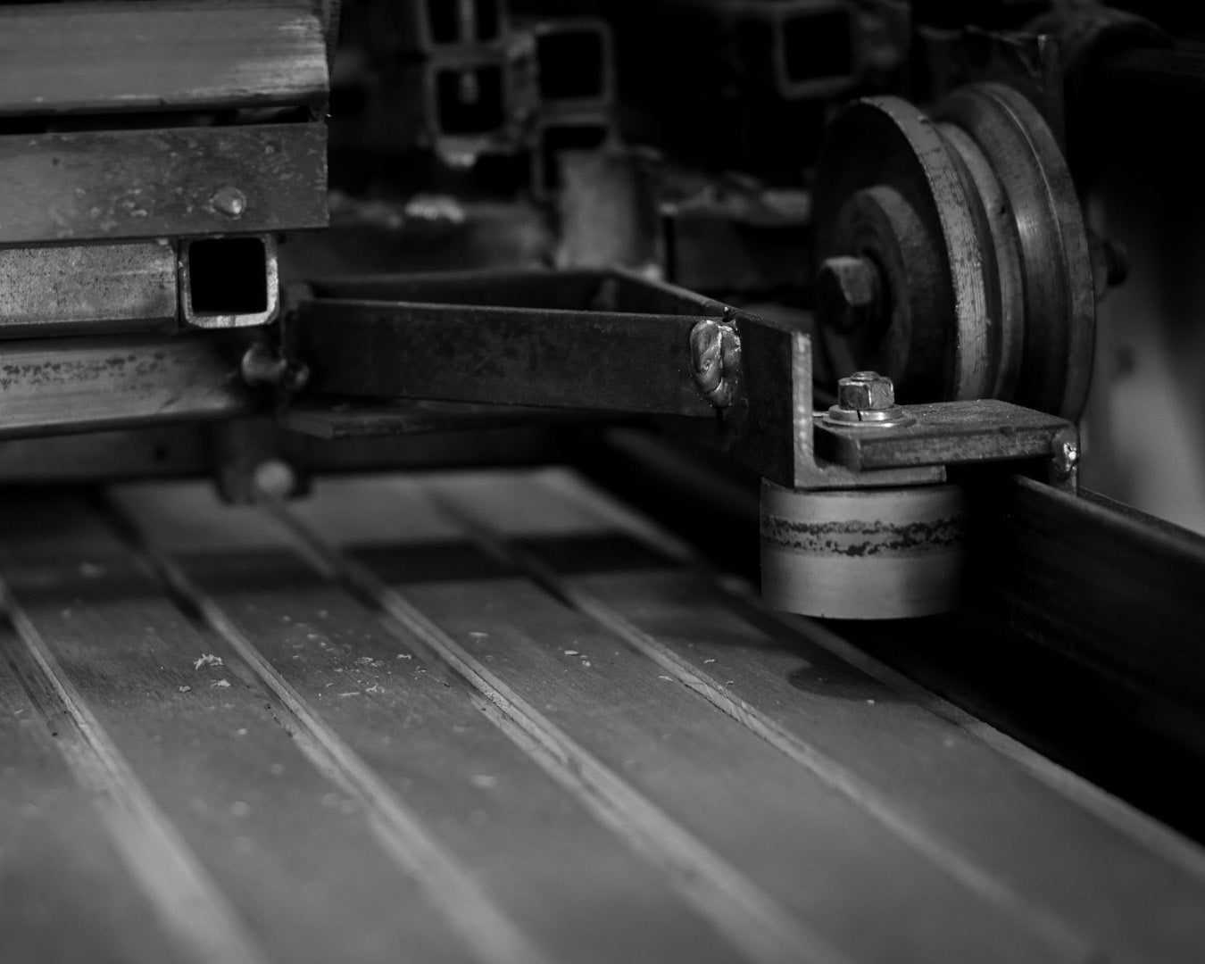 Close up of a wheel and track which is part of one of Vintage Plywood's milling machines