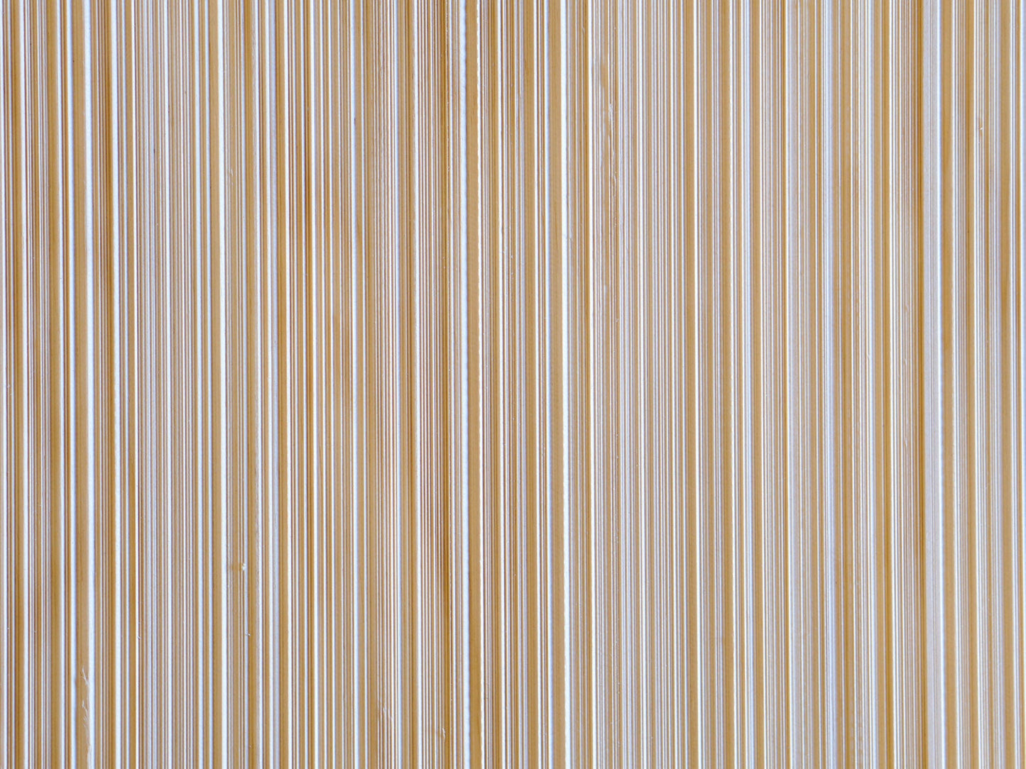Close up of Weldtex plywood pattern consisting of a combed, striated, brushed wood appearance common in mid-century modern homes and design