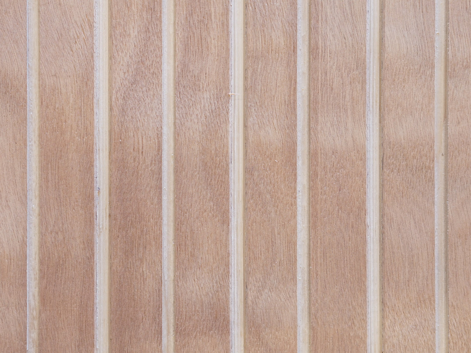 Close up of Vintage Plywood Millworks' Wideline siding showing the wide grooves and wood grain pattern