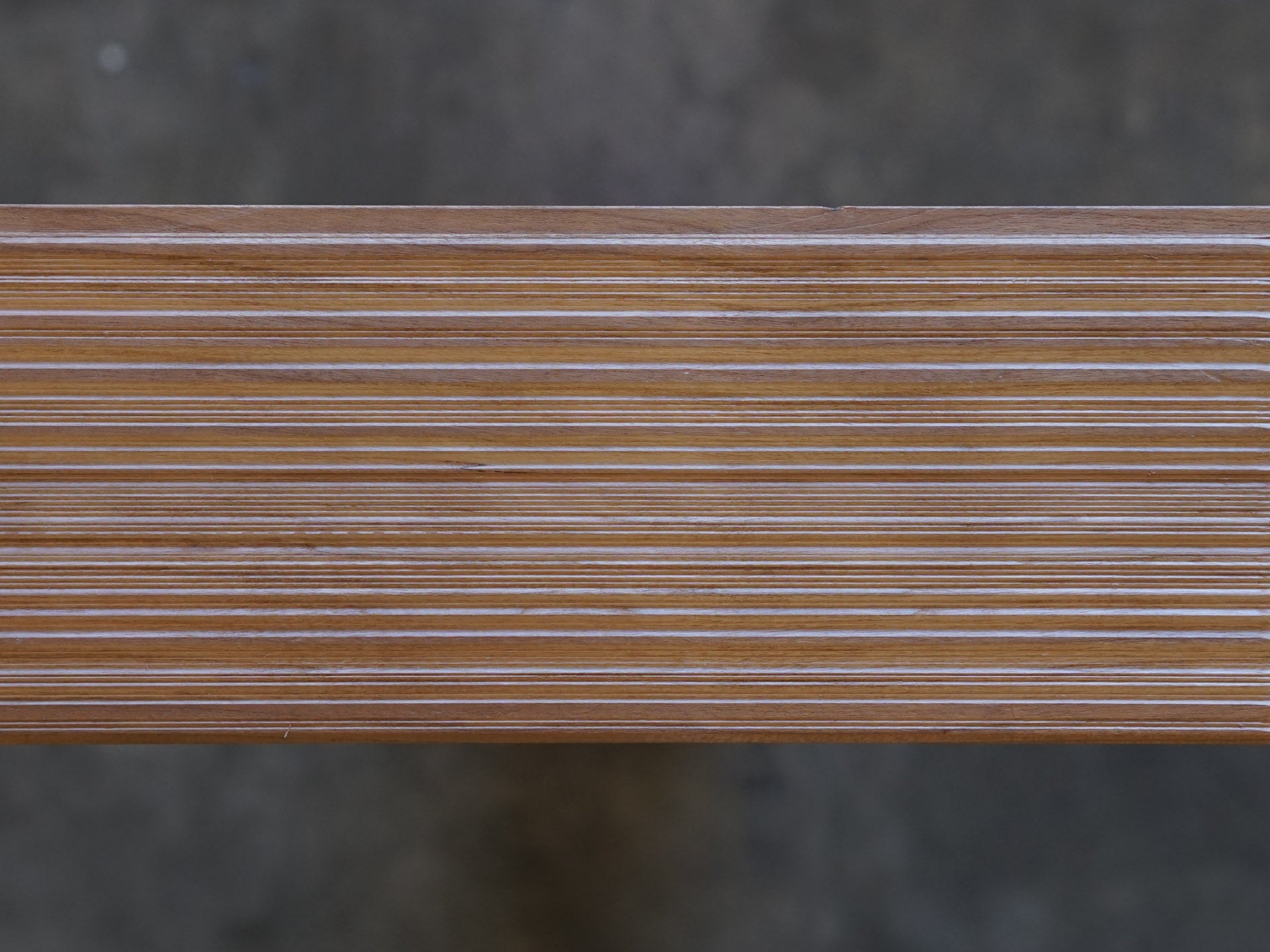 Top down photo of Weldtex tongue & groove cherry hardwood plank consisting of a combed, striated, brushed wood appearance common in mid-century modern homes and design