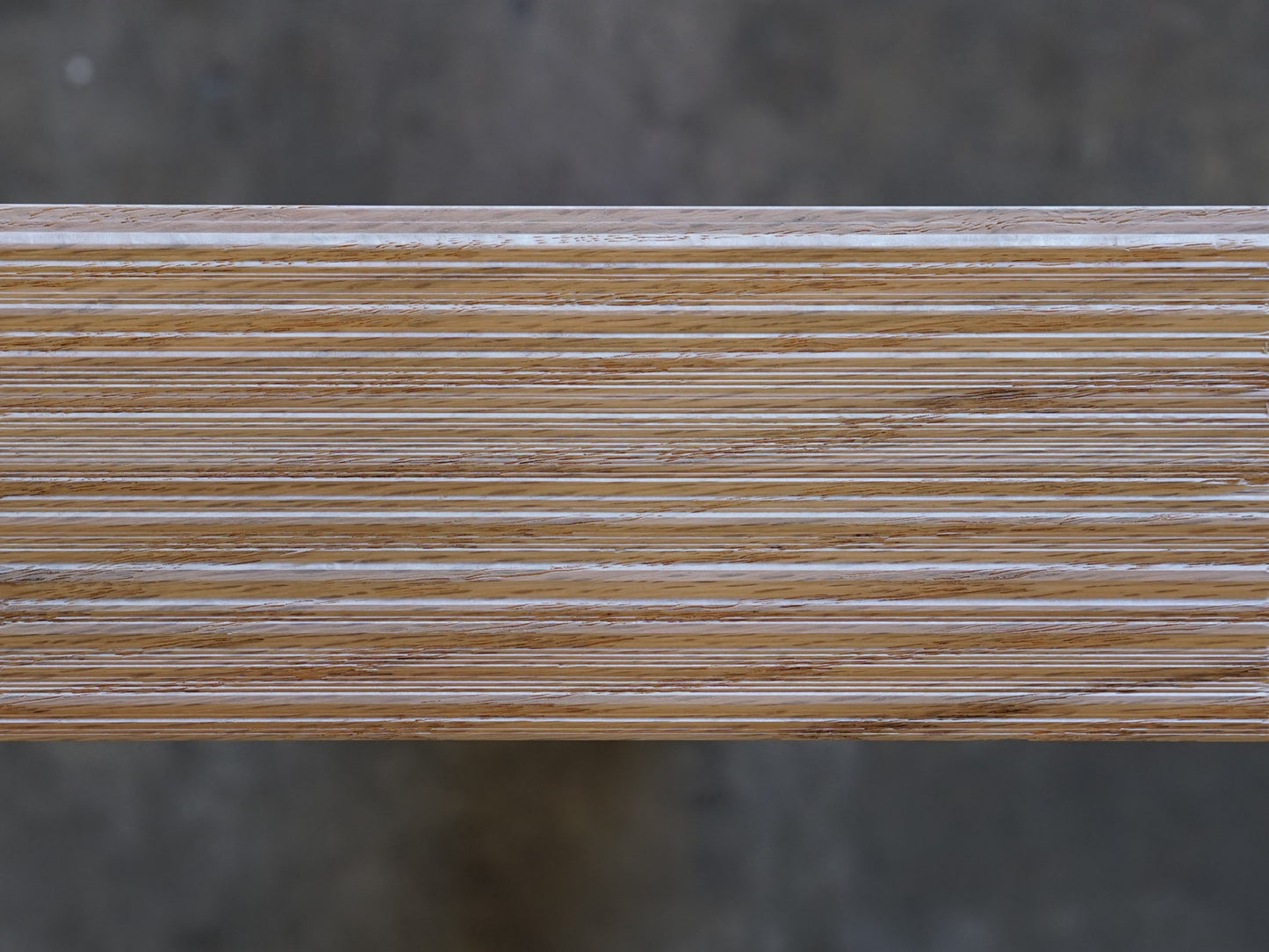Top down of Weldtex tongue & groove red oak hardwood plank consisting of a combed, striated, brushed wood appearance common in mid-century modern homes and design