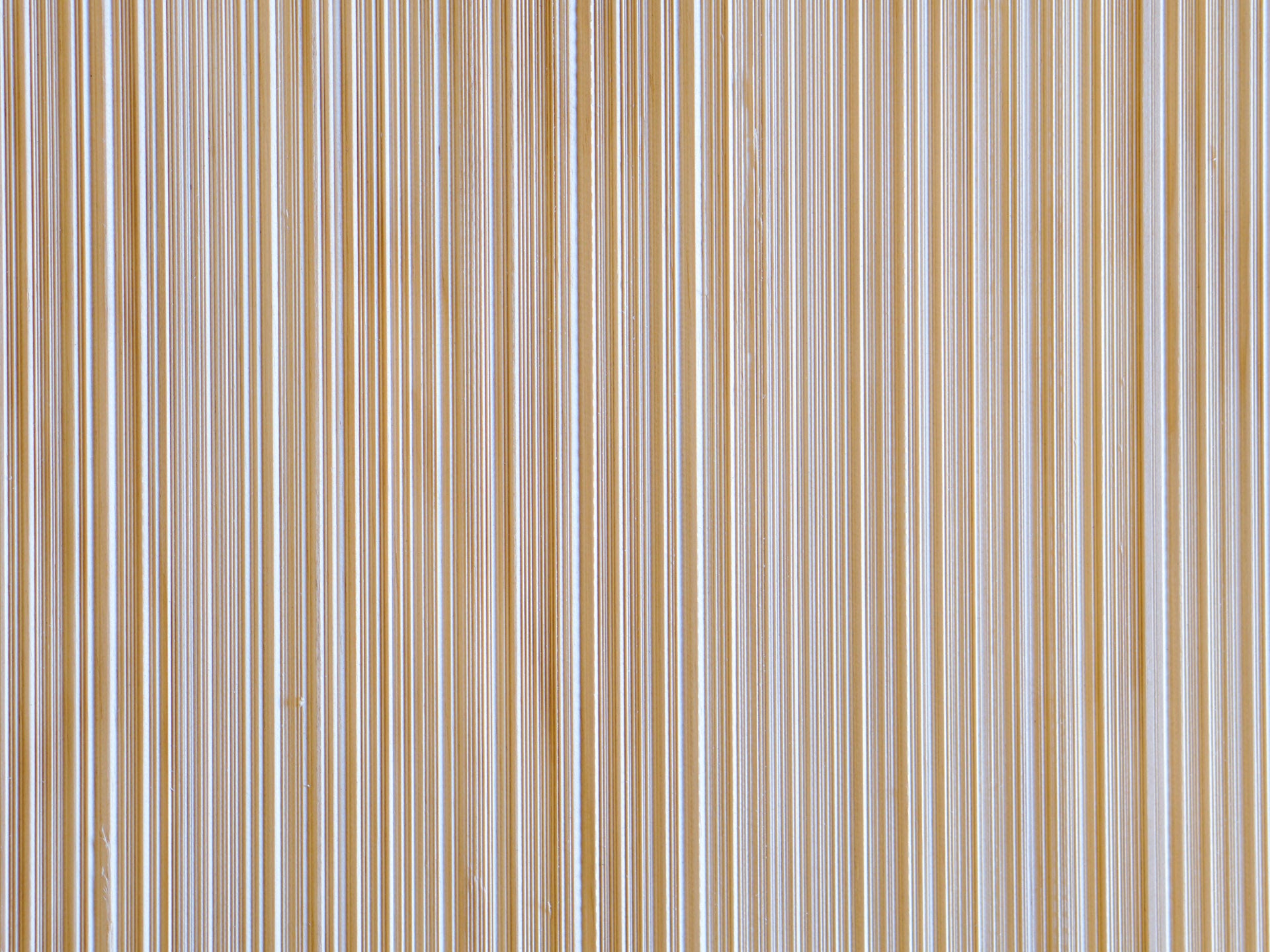 Close up of Weldtex plywood pattern consisting of a combed, striated, brushed wood appearance common in mid-century modern homes and design