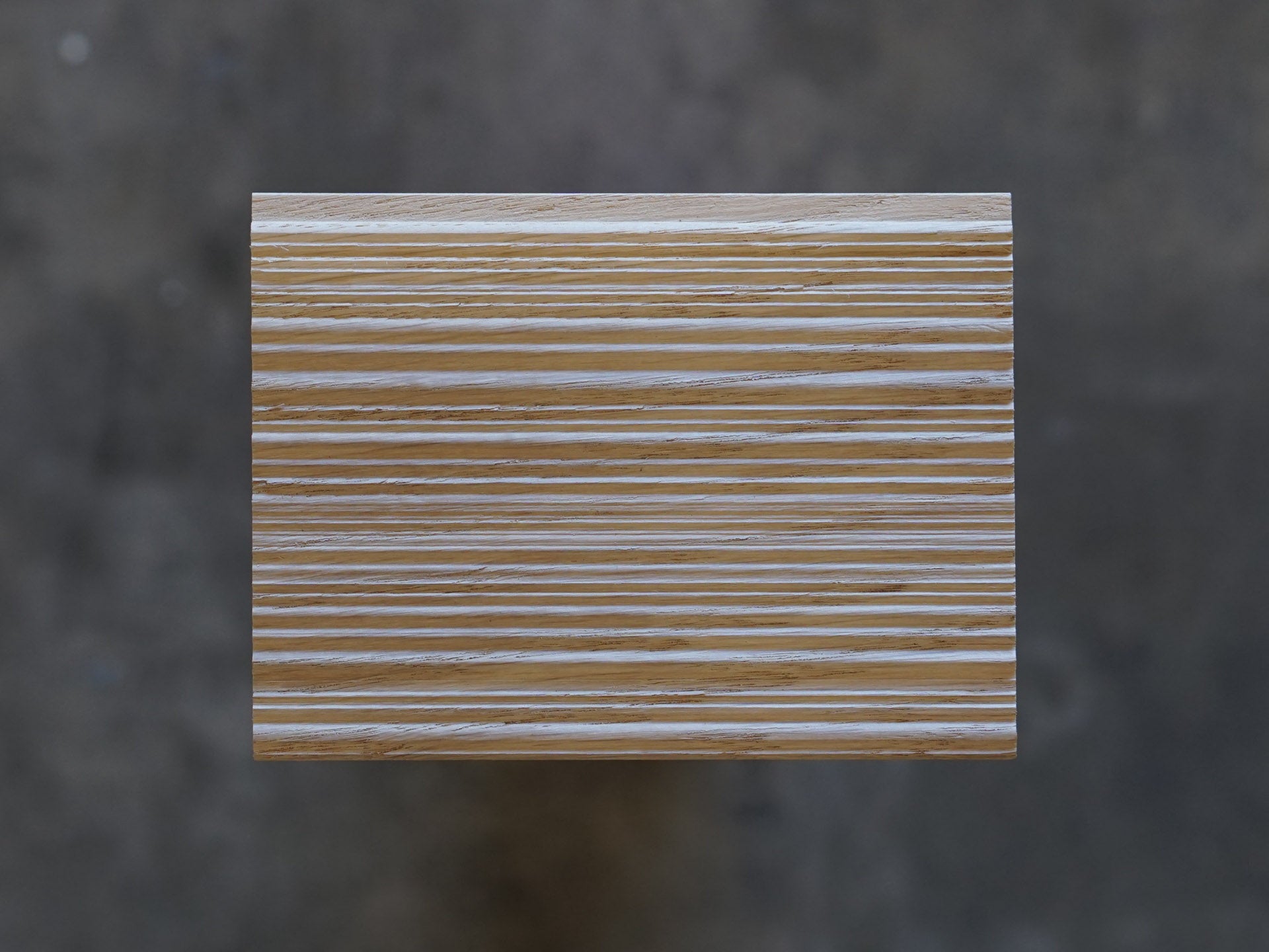 Top down of Weldtex tongue & groove white oak hardwood plank consisting of a combed, striated, brushed wood appearance common in mid-century modern homes and design